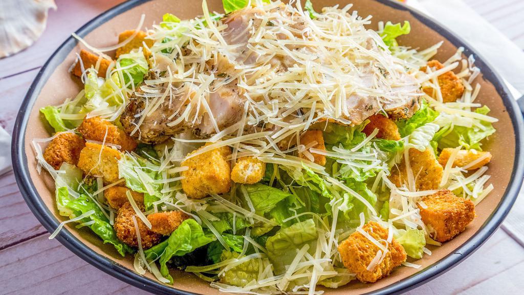 Caesar Salad · Crispy romaine, Parmesan cheese, and croutons tossed with a creamy Caesar dressing. Add Chicken or Kalua Pork for an additional charge.
