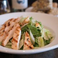 Grilled Chicken Caesar Salad · Grilled chicken, parmesan, shaved Grana-Padano, toasted garlic, croutons, and Caesar* dressing