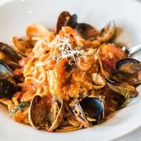 Linguine Pescatore · Scallops, prawns, clams, mussels and fresh fish, sautéed in a garlic tomato sauce