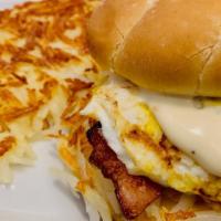 The Monster Sandwich · Ham, bacon, eggs, hash browns, cheddar, and country sausage gravy served with potatoes or ha...