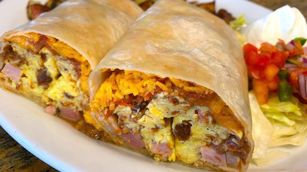 Breakfast Burrito · Ham, bacon or sausage, eggs, cheddar, beans, and salsa served with potatoes or hash browns.