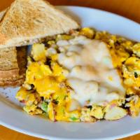 Mama'S Scrambler · Sausage, ham, onions, bell peppers, tomatoes, eggs, potatoes, jack, and cheddar served with ...