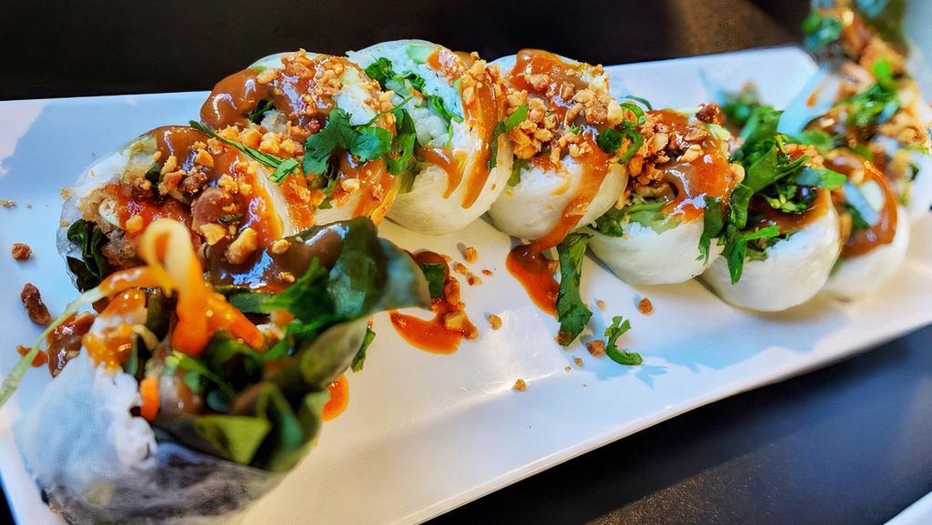 Vegan Lover’S Roll · Spicy. Rice paper wrapped in lettuce mix, bean sprouts, noodles, mints, crispy tofu & avocado, topped w/ peanut sauce, flavored sriracha sauce, crushed peanuts, onions & cilantro mix.