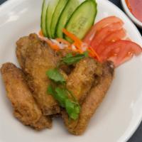 Crispy Chicken Wings · Six wings served with a house special sauce and a side of pickled carrots and daikon.