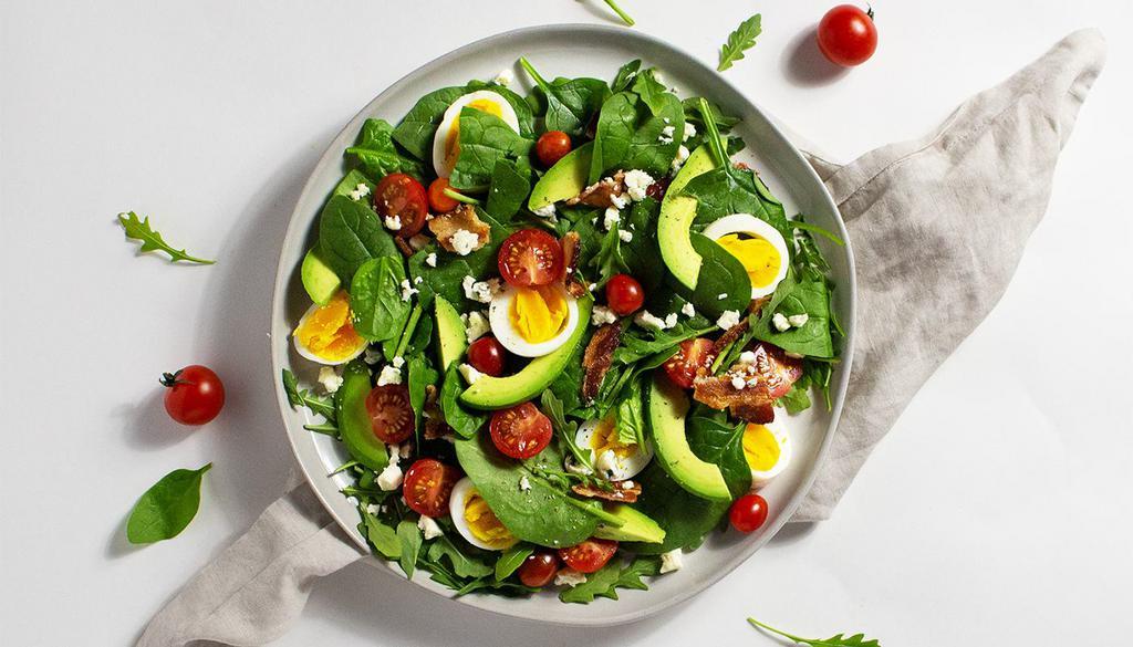 Cobb Salad · Hard boiled egg, bacon, avocado, and tomato  with your choice of greens and dressing.