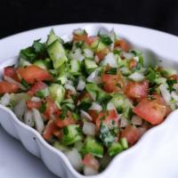Shirazi Salad · Diced tomatoes, cucumbers, onions, parsley, in olive oil and lemon juice.
