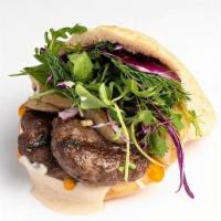 Kefta Pita · Ground lamb and beef grilled over coals with tahina, amba, chopped salad, grilled onion and ...