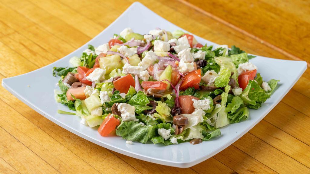 Greek Salad · Lettuce, tomatoes, cucumbers, feta cheese, olive oil, parsley, red onions topped with greek dressing.