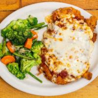 Chicken Parmigiana · Served with a side of vegetables and pasta with marinara. Breaded and baked with marinara sa...