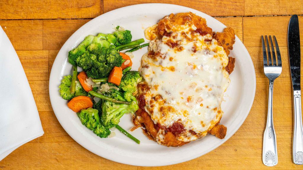 Chicken Parmigiana · Served with a side of vegetables and pasta with marinara. Breaded and baked with marinara sauce and mozzarella cheese.