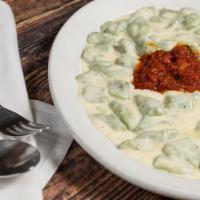 Spinach Gnocchi · Homemade spinach and potato dumplings in a white cream sauce and a drop of marinara.