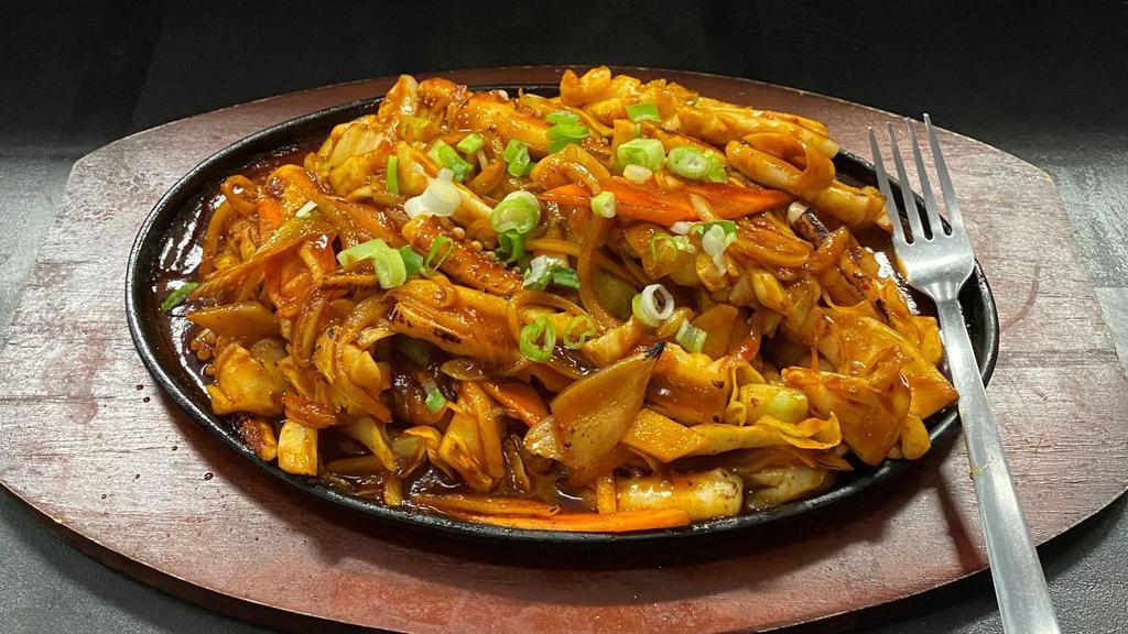 Ojingeo-Bokkeum/오징어볶음/炒鱿鱼 · This dish is made by stir-frying squids, onions, carrots and cabbage in a spicy sauce of Tochu-jang (red chili pepper paste) and gochut-garu(red chili pepper powder).