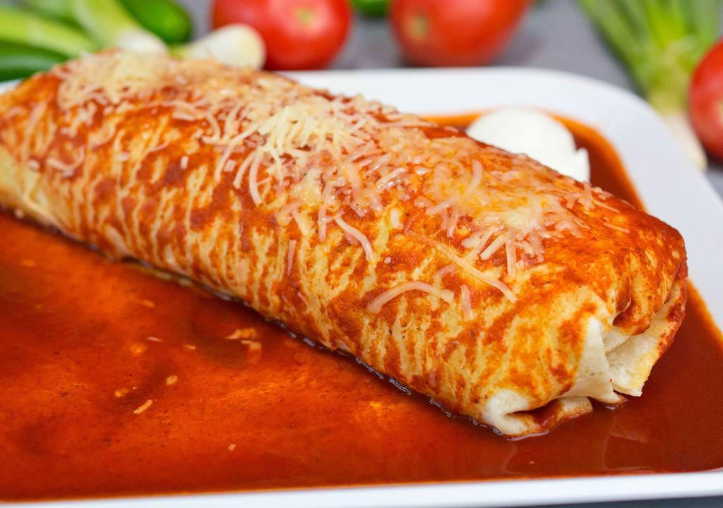Wet Burrito · Flour tortilla, rice, whole beans, choice of meat, onions, and cilantro. Topped with salsa, cheese, and sour cream.