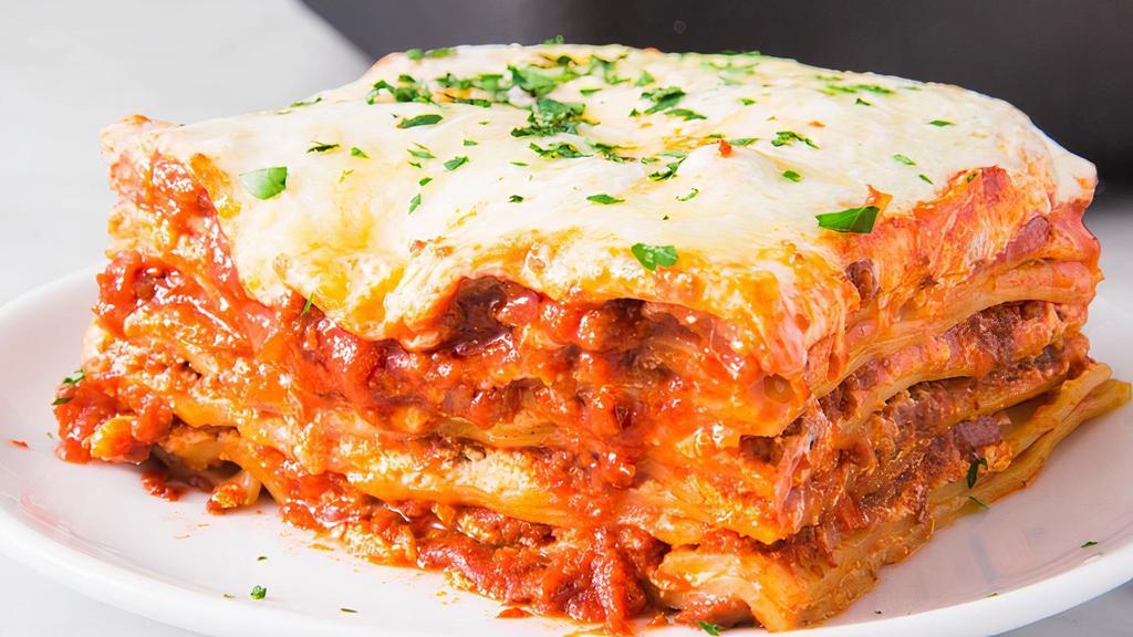 Homemade Meat Lasagna · Pasta layered with Italian sausage ground beef, fresh ricotta cheese, mozzarella cheese, Parmigiano cheese, marinara sauce, and fresh basil.