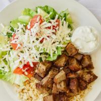 Gyro Plate · Lamb gyro meat over rice served with a garden salad and pita bread. Served with Greek salad ...