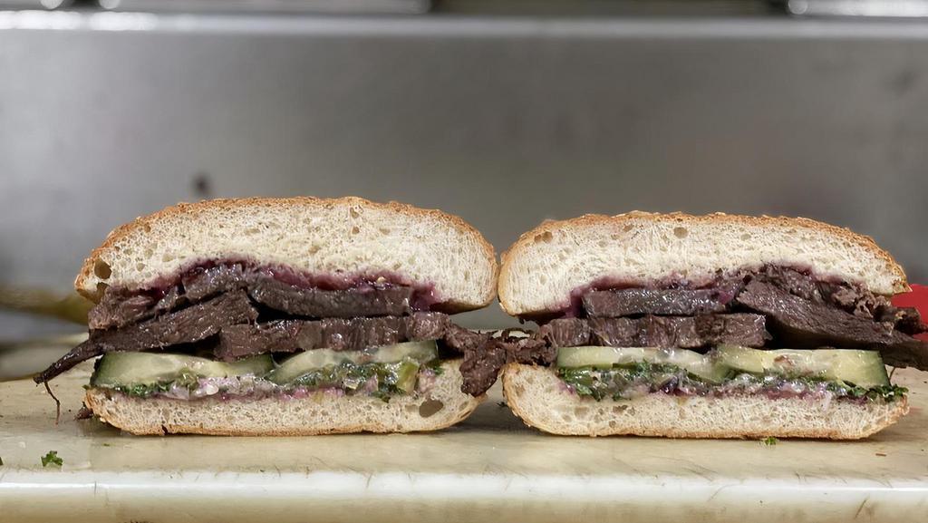 Beef Tongue Sandwich · Our most popular sandwich. Grass-fed beef tongue slow cooked overnight with our minced herb-onion mix, garlic dill pickle, tomato, and our original house dressing