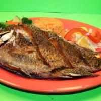 Pescado  Frito · Deep fried tilapia fish served with rice, vegetables, and salad. (4 corn tortillas).
