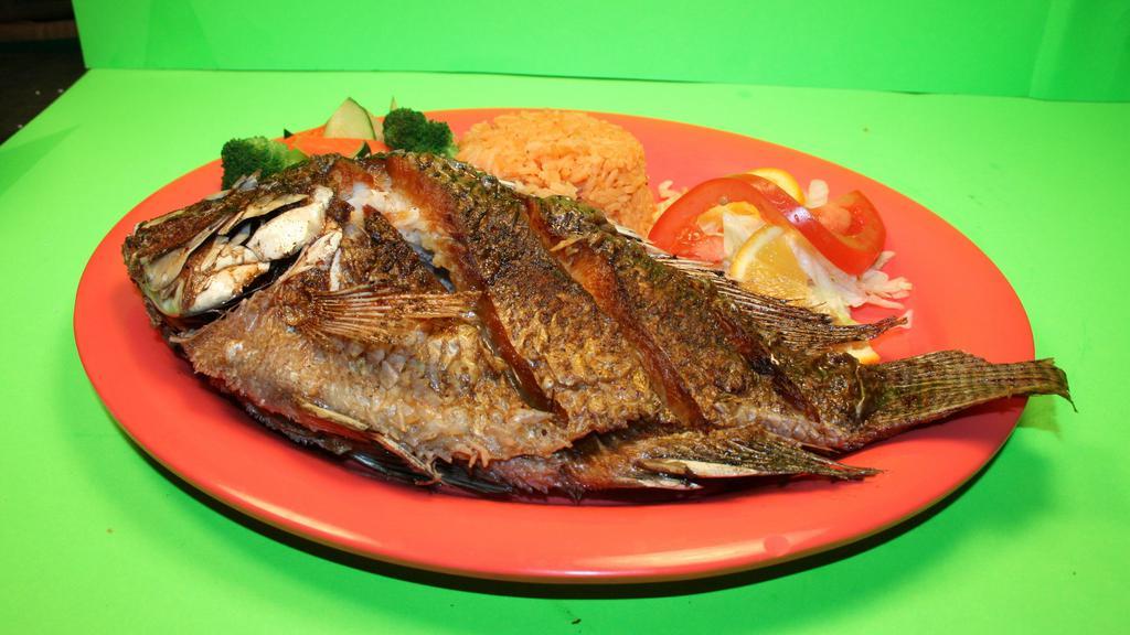 Pescado  Frito · Deep fried tilapia fish served with rice, vegetables, and salad. (4 corn tortillas).