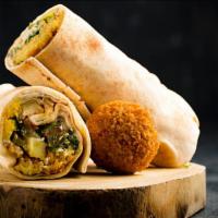 Falafel Wrap · Crispy falafels, lettuce, tomatoes, tahini wrapped in a warm homemade pita served with choic...
