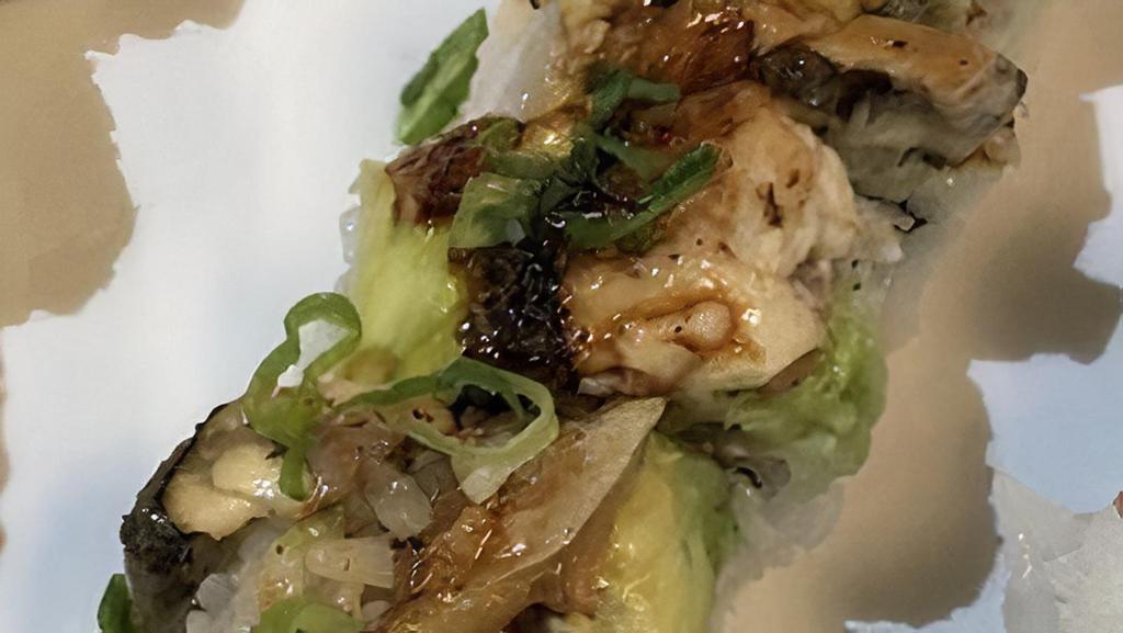 Dragon Roll · Outside: unagi. Inside: avocado, crabmeat, cucumber. Toppings: unagi sauce, green onion.