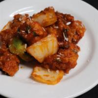 Chili Chicken · Chicken sautéed with green chilis, onions, bell pepper and cooked in garlic sauce.