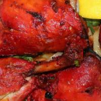 Tandoori Chicken · Seasoned chicken in rare spices and yogurt, cooked in tandoor.
