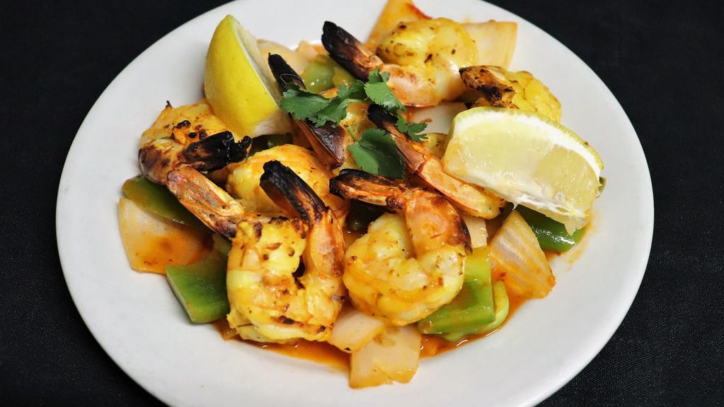 Tandoori Shrimp · Jumbo shrimp marinated in tikka seasoning, cooked in tandoor.