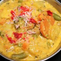 Vegetable Korma · Mixed veggies cooked in a creamy coconut sauce topped with nuts and raisins.