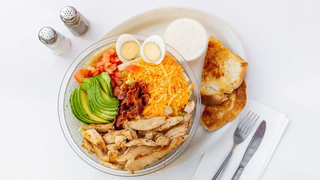 Cobb Salad · Grilled Chicken, bacon, avocado, tomatoes, hard boiled egg, and Cheddar cheese. Served with garlic toast