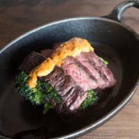 Grilled Hanger Steak · Grilled over white oak, and sliced against the grain for tenderness, topped with smoked papr...