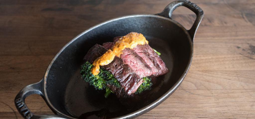 Grilled Hanger Steak · Grilled over white oak, and sliced against the grain for tenderness, topped with smoked paprika, chimichurri, and broccolini