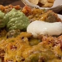 Velasco'S Nachos · Our house made tortilla chips topped with your choice of meat, beans, cheese, salsa, and a s...