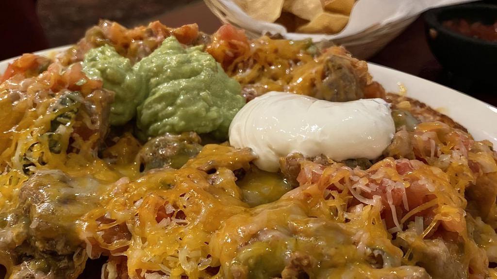 Velasco'S Nachos · Our house made tortilla chips topped with your choice of meat, beans, cheese, salsa, and a small portion of guacamole and sour cream.