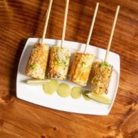 Roasted Street Corn · Roasted corn on the cob rubbed with cilantro butter, cotija cheese, parmesan cheese, tajin, ...