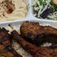 Lamb Chops Plate · Grilled lamb chops marinated in special spices served with rice, salad, hummus, and pita bre...