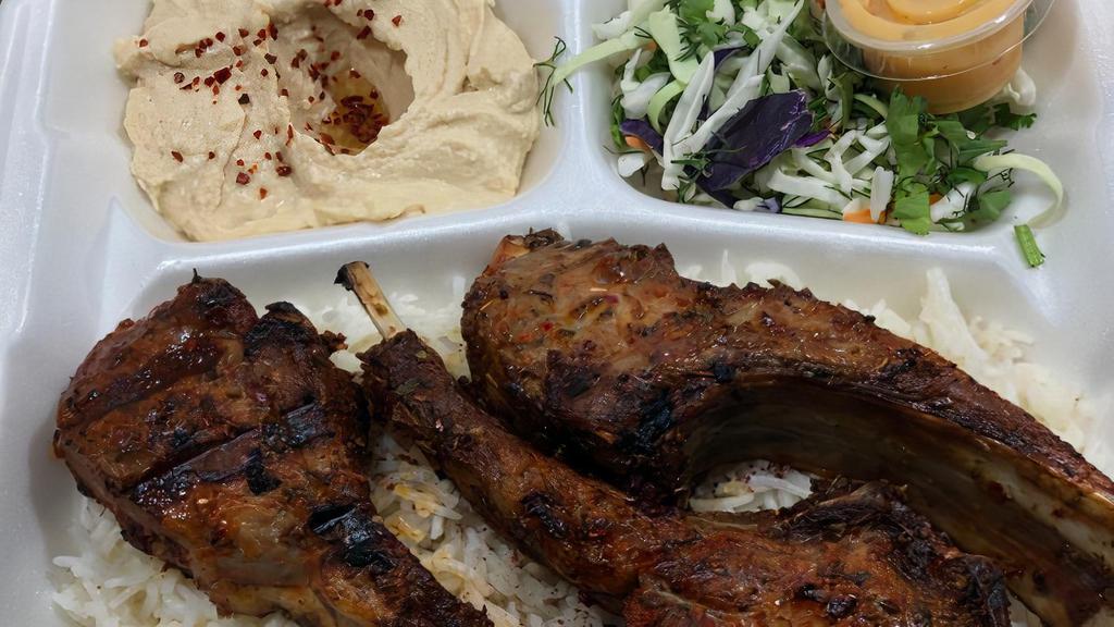 Lamb Chops Plate · Grilled lamb chops marinated in special spices served with rice, salad, hummus, and pita bread.