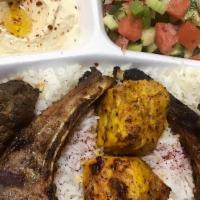 Shish Kabob Combo Plate · Two pieces of lamb chops, chicken, and filet mignon shish are served on a bed of rice, with ...
