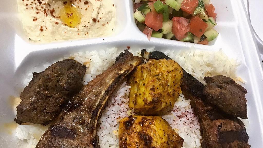 Shish Kabob Combo Plate · Two pieces of lamb chops, chicken, and filet mignon shish are served on a bed of rice, with sides of salad, hummus, and pita bread, also served with grilled tomato and grilled Jalapeño.