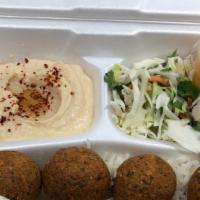 Falafel Plate · Falafel balls mixed with spices served on a bed of rice, sides of salad and hummus, topped w...