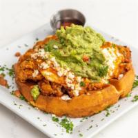 Huevos Rancheros · With queso fresca, refried beans, fried egg, guacamole, and red salsa.