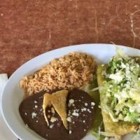 Green Chicken Enchiladas Plate · 2 deep fried tortillas, filled with chicken, topped with green flavorful sauce, lettuce, sou...