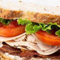 Classic Turkey Club Sandwich · roasted turkey breast, niman ranch bacon, tarragon aioli, lettuce, tomato, nine grain bread