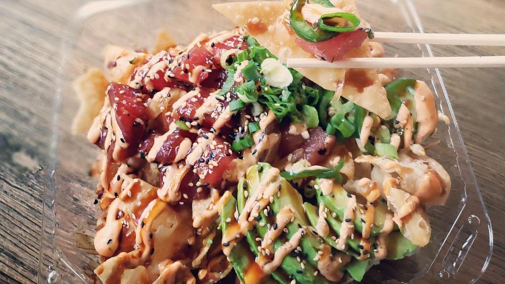 Poke Nachos · Spicy. With protein, avocado, green onion, jalapeno, sesame seeds, spicy mayo and teriyaki sauce over wonton chips.