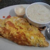 Two Eggs · Served with grits, hash brown potatoes or rice with toast.