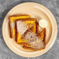 French Toast · Two slices of french toast topped with powdered sugar and cinnamon.