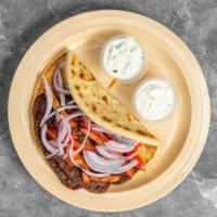 Gyro Pita · Four strips of gyro meat, tomato, red onions wrapped in a pita bread with tzatziki sauce on ...