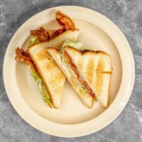 B L T · Classic bacon, lettuce and tomato sandwich with mayonnaise on white toast.