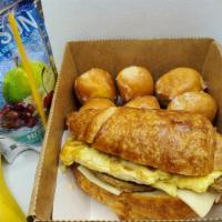 Mini Combo Egg Sausage And Cheese  · Toasted mini croissant serve with haft slide of egg, haft slide of cheese and 1 slide of sau...