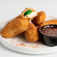 Spicy Jalapeno Chili Bombs · Five - crunchy cream cheese stuffed jalapenos served with house-made fire craker sauce.