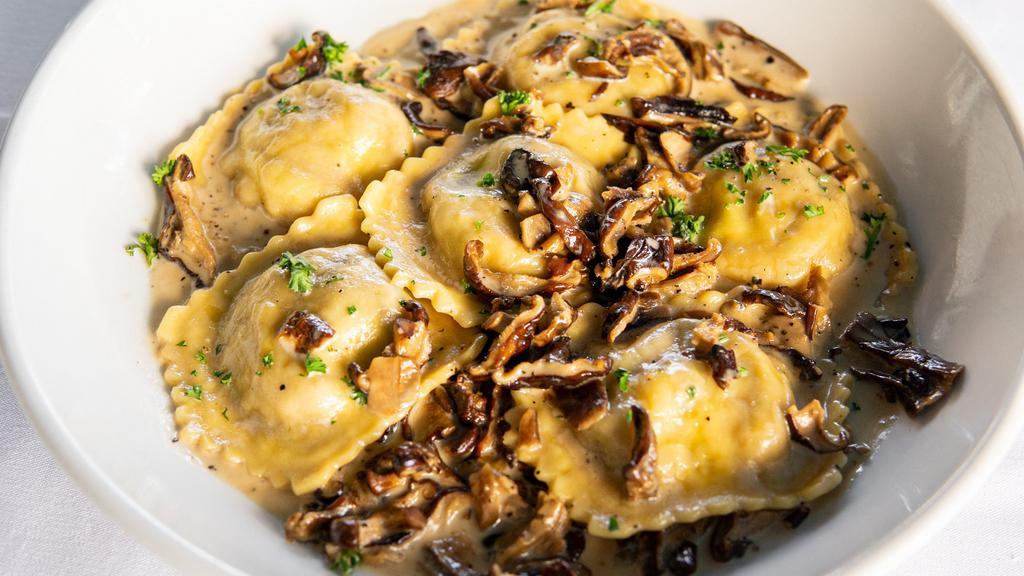 Veal Ossobuco Raviolis · Homemade raviolis served with mixed wild porcini mushrooms in a light garlic cream sauce.
